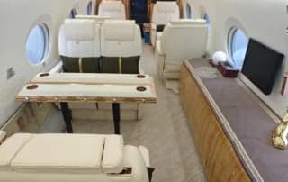 Interior of the aircraft with seats and a table.