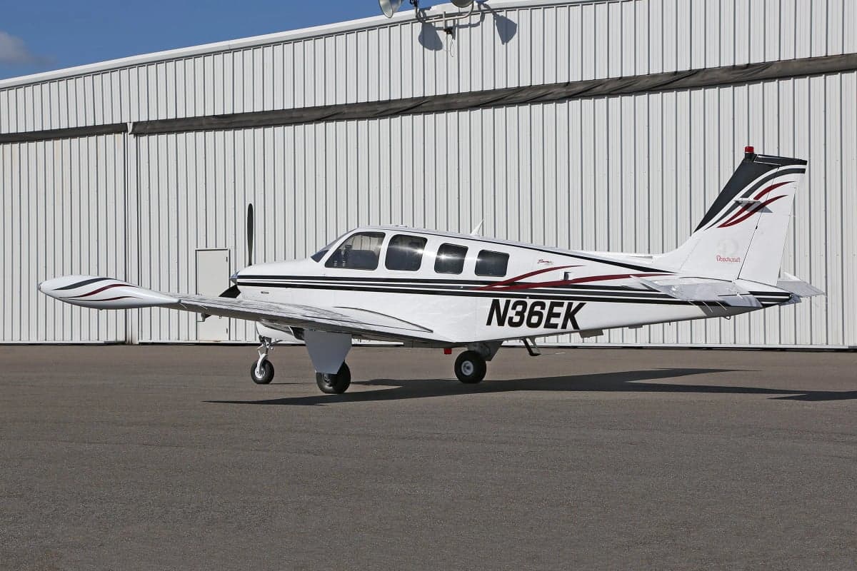 Side view of a Beechcraft Bonanza on the tarmac with registration number N36EK.