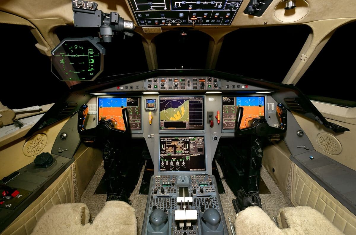 The cockpit of a Falcon aircraft with full instrumentation.