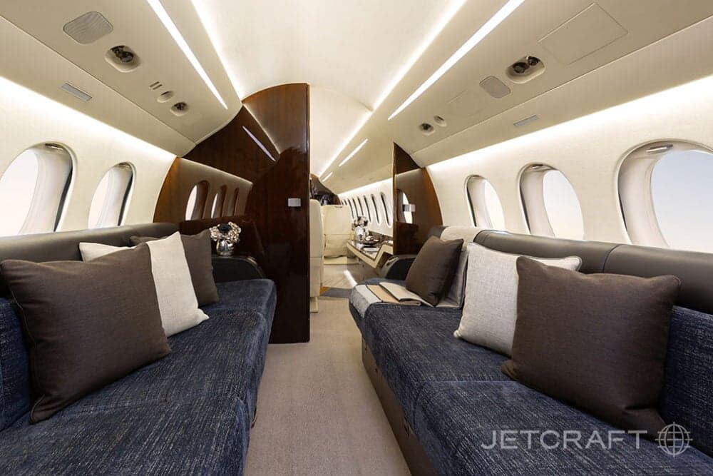 The aircraft's interior features a lounge area with comfortable seating.