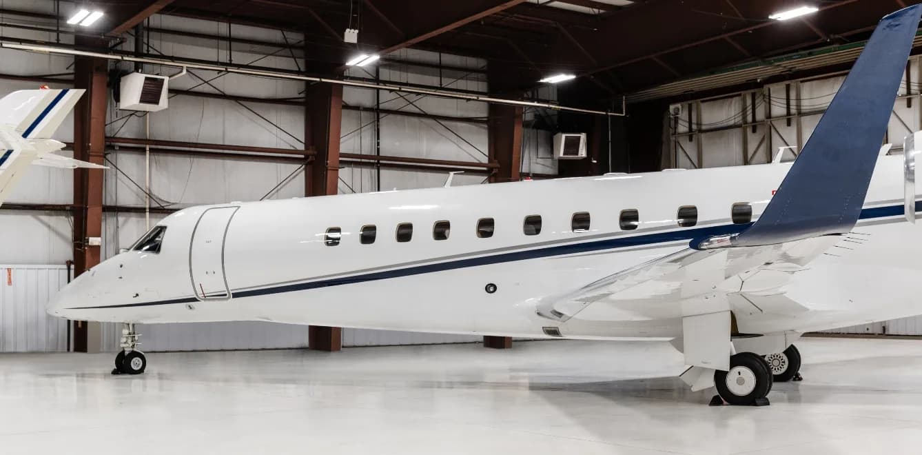 Close-up side view of the N645PM Embraer Legacy 450 in a hangar.