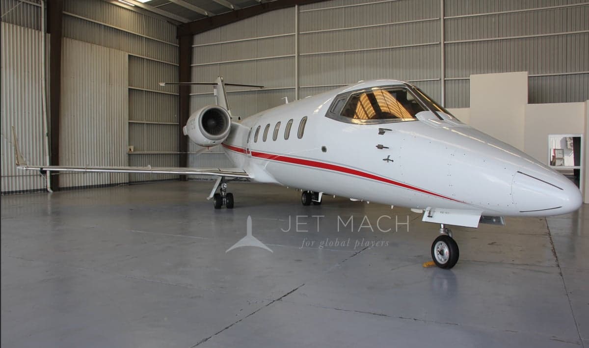 Front quarter view of the N317EC aircraft in a hangar, showcasing its sleek design.