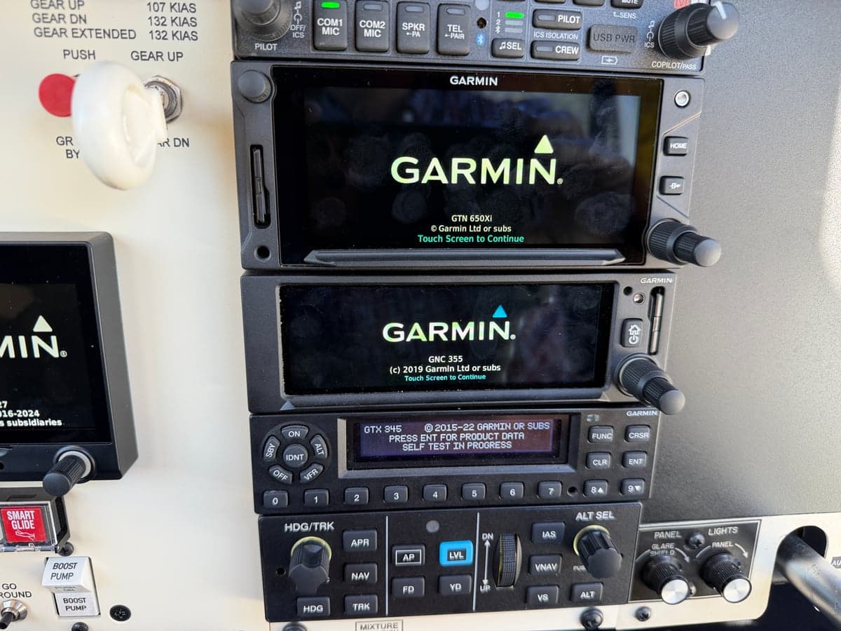 Close-up of the Garmin avionics units in the Mooney M20J cockpit, displaying the Garmin logo.
