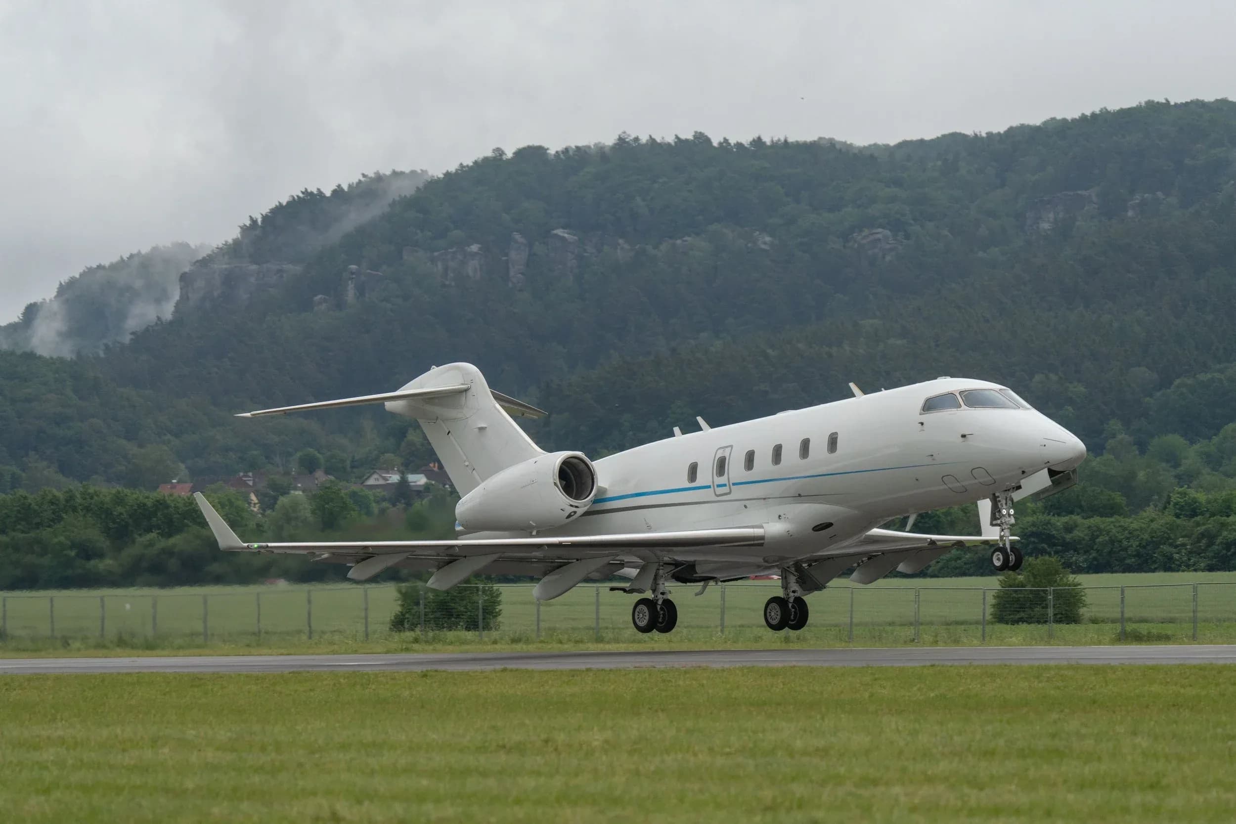 Challenger aircraft taking off from a runway.
