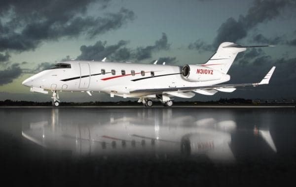 A white jet aircraft with red and black stripes on a wet tarmac.