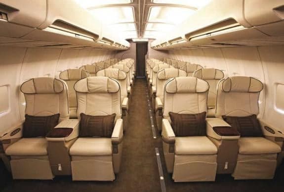 Interior of a private jet with comfortable seating.
