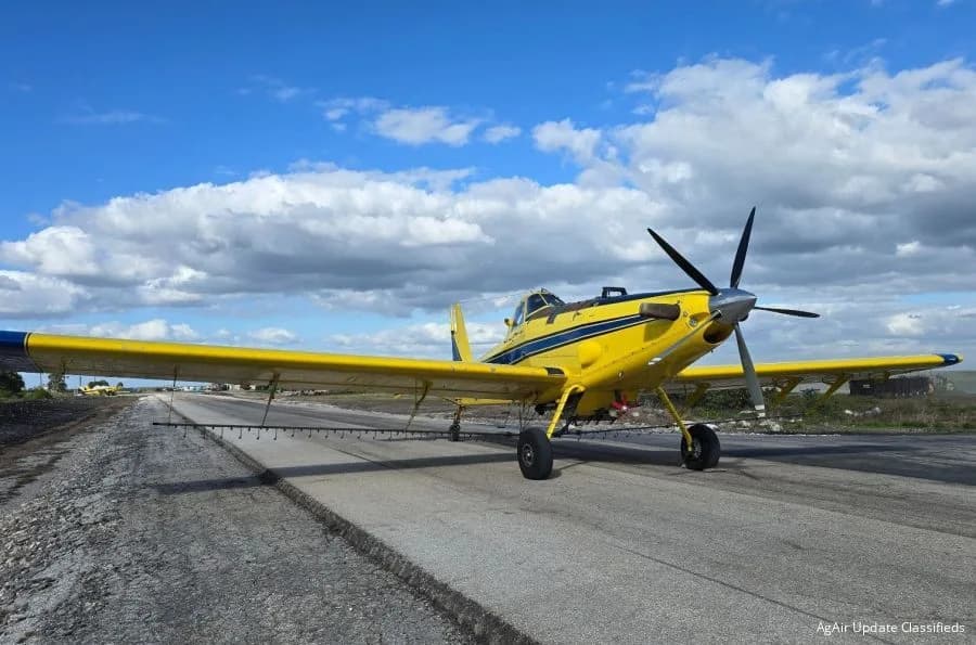 Yellow and blue Air Tractor AT-502 on a runway.