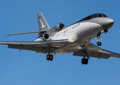 C-FXOO aircraft in flight with landing gear down.