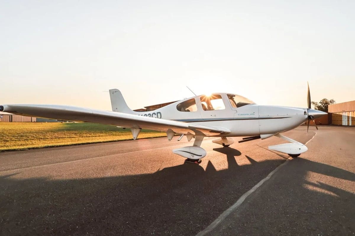 Cirrus SR22 aircraft N133CD parked on the tarmac, side view.