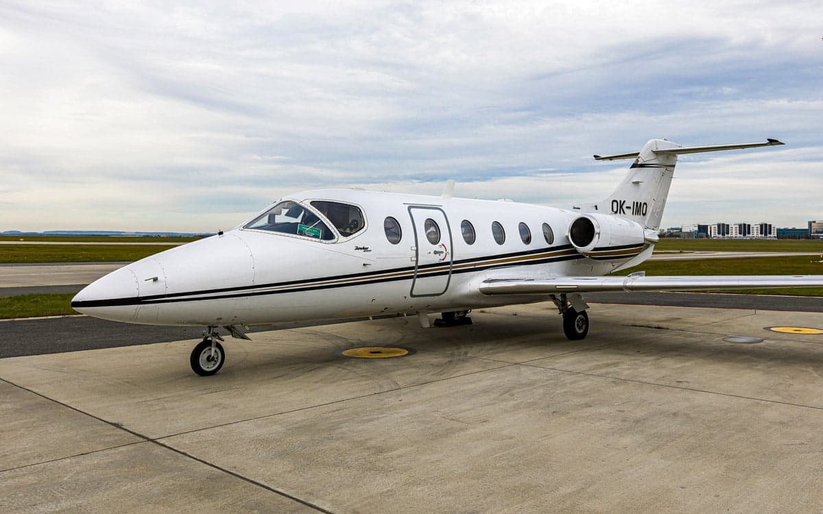Beechjet 400A aircraft with registration OK-IMO parked on the tarmac.