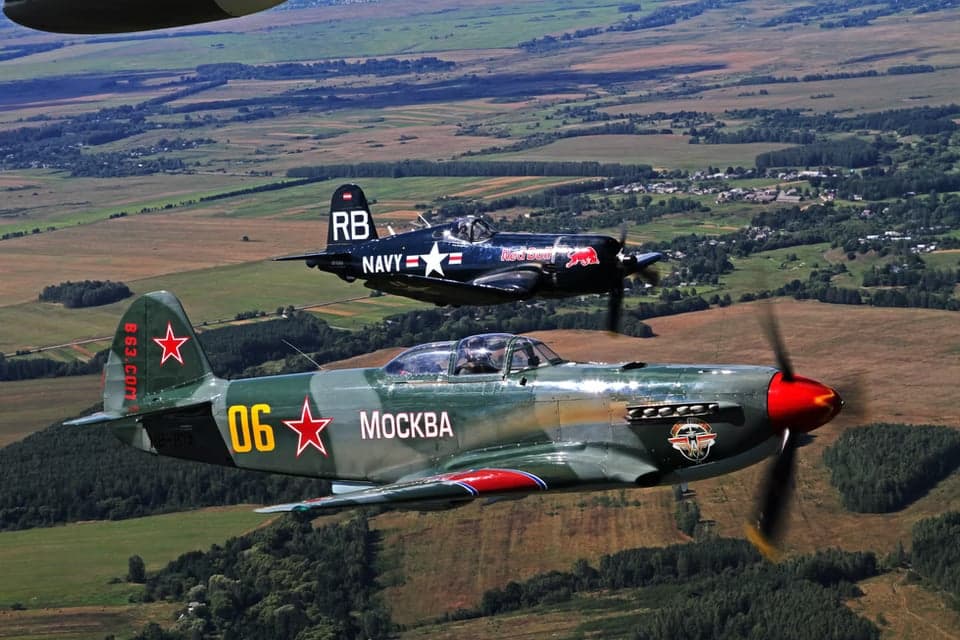 Yak-3 in flight over the ocean.