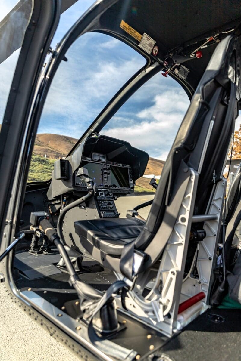 View of the helicopter cockpit from the open door.