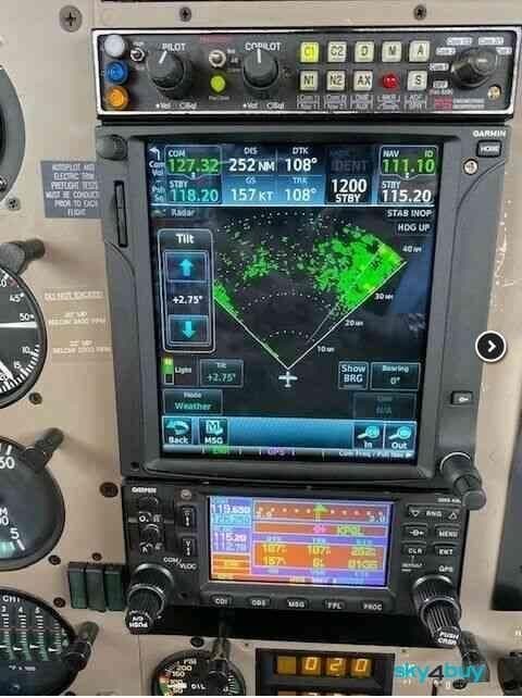 Close-up of the aircraft's avionics and radar display in the cockpit.