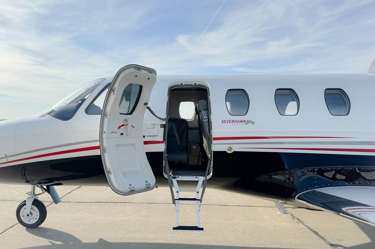 Close-up of the open door and steps of a Cessna Citation CJ3+ aircraft, showing the Silverhawk Aviation logo.