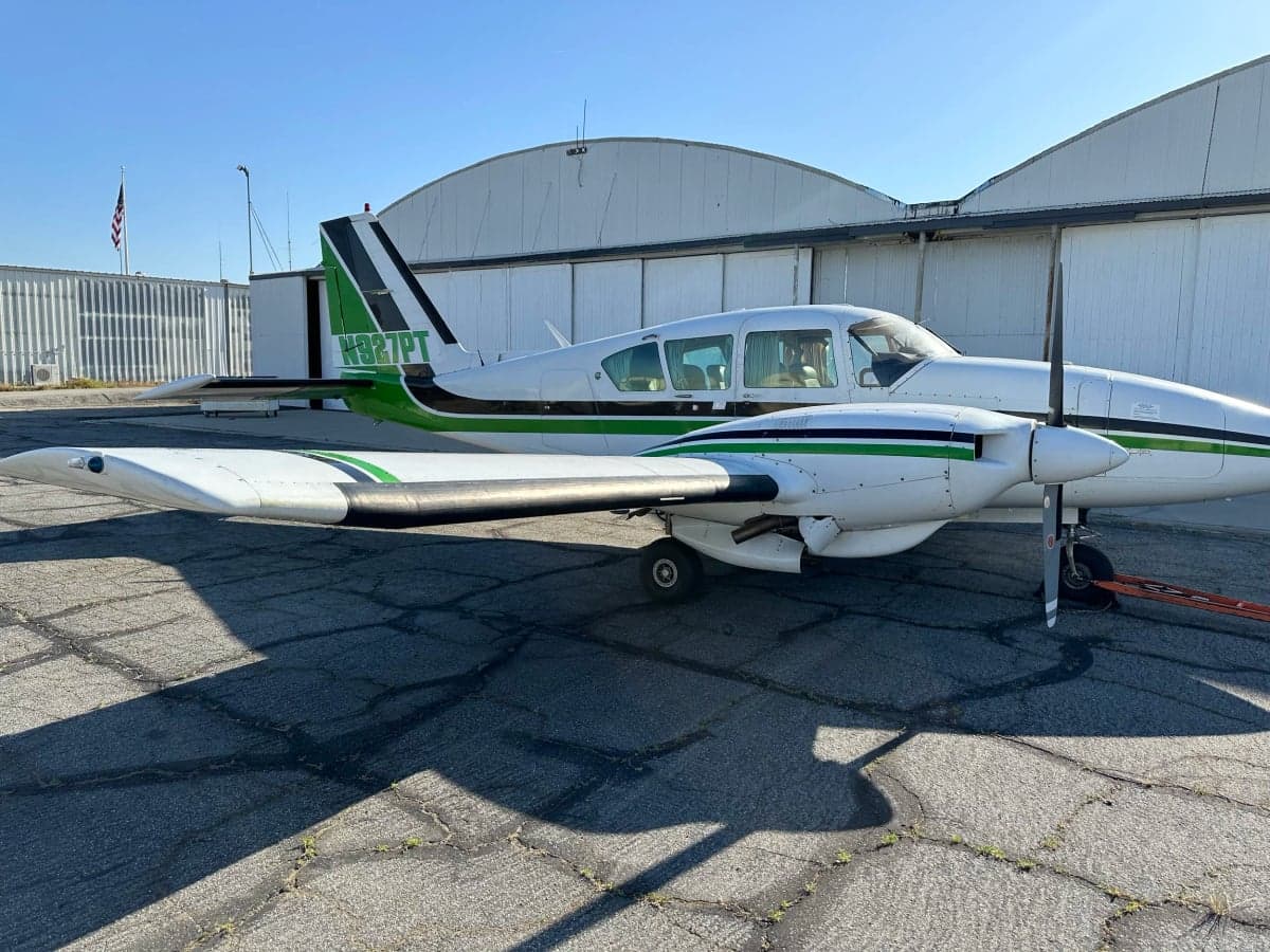 N927PT aircraft parked on the tarmac in front of a hangar.
