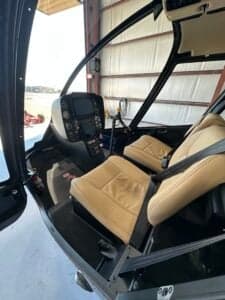 The interior of the Robinson R66 helicopter features tan leather seats.