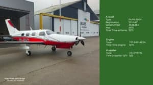 A Piper PA46-350P Mirage, registration SP-NAZ, parked in front of a hangar, with aircraft specifications.