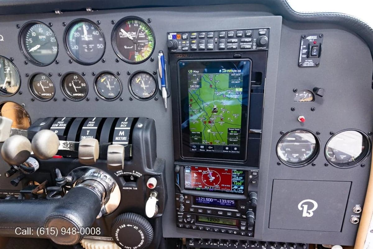 A detailed view of the right side of the aircraft's instrument panel, highlighting the navigation display, radio stack, and engine controls.