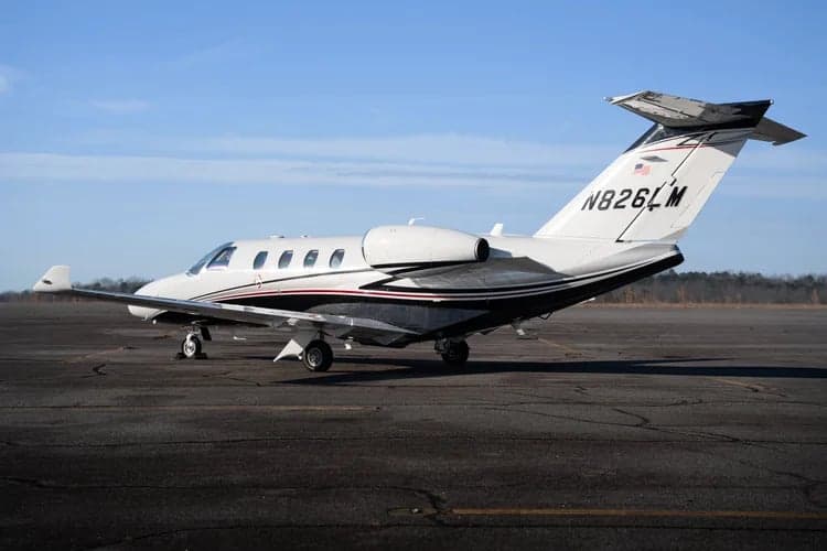 A Cessna Citation CJ3 aircraft is parked on the tarmac, showing its tail number N826LM.