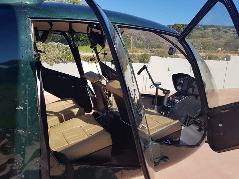 Interior view of the Robinson R44 Clipper helicopter, showing the seats and cockpit.