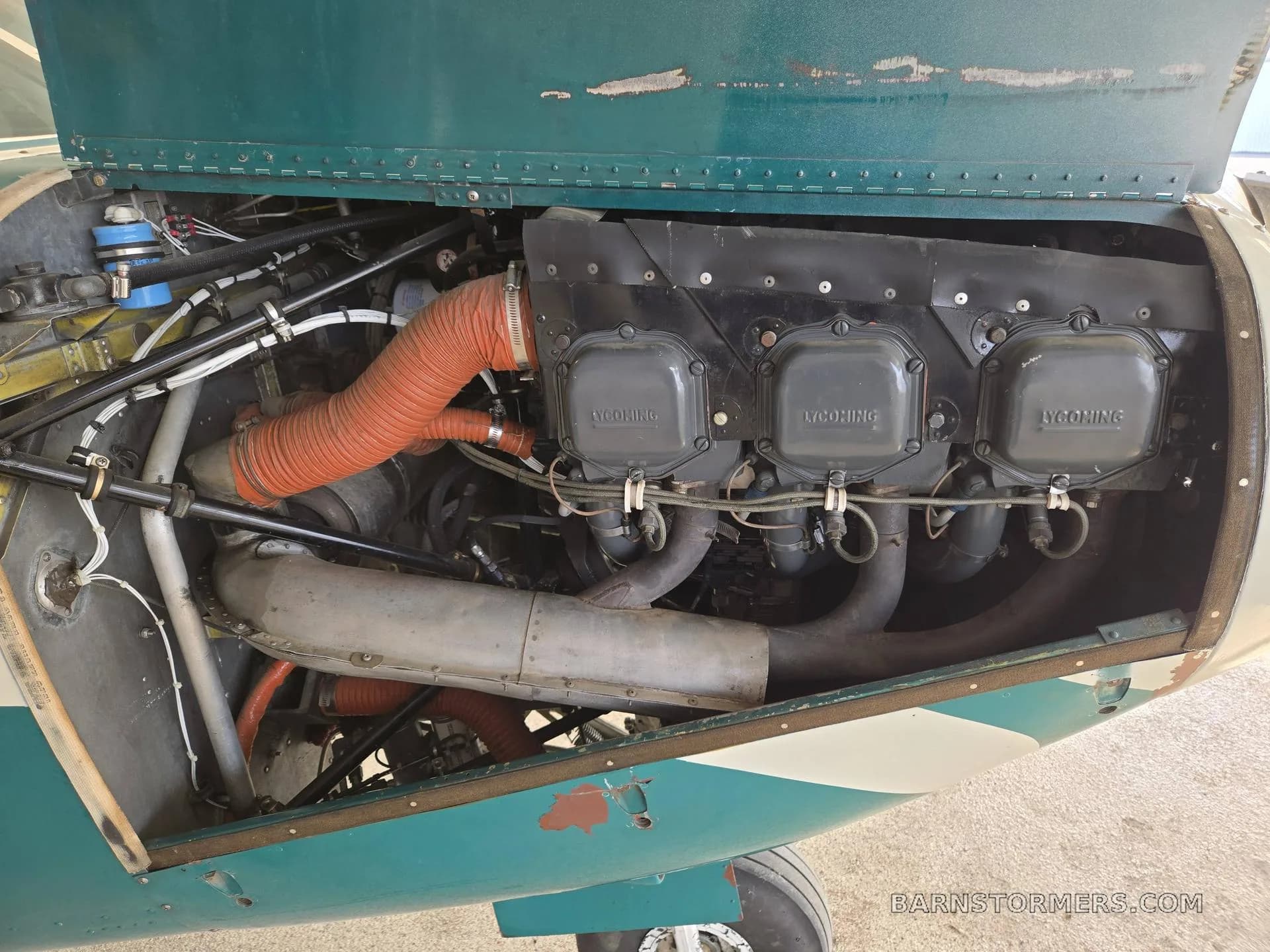 An open cowling view of the Lycoming engine inside a Piper Comanche 250 aircraft.