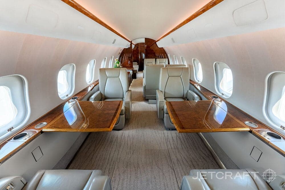 View of the aircraft interior with tables extended between the seats.