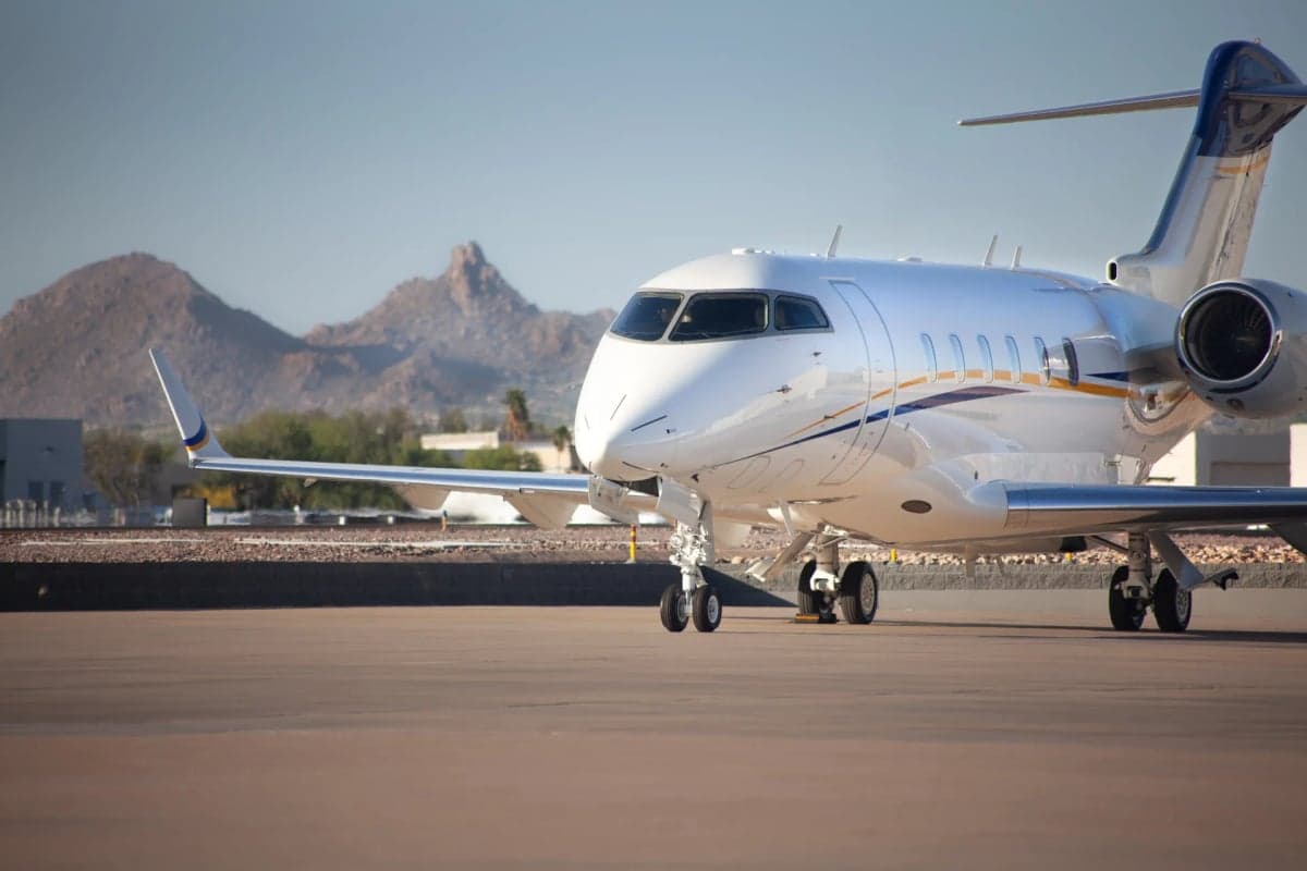Front view of the N4BZ aircraft on the tarmac with mountains in the background.