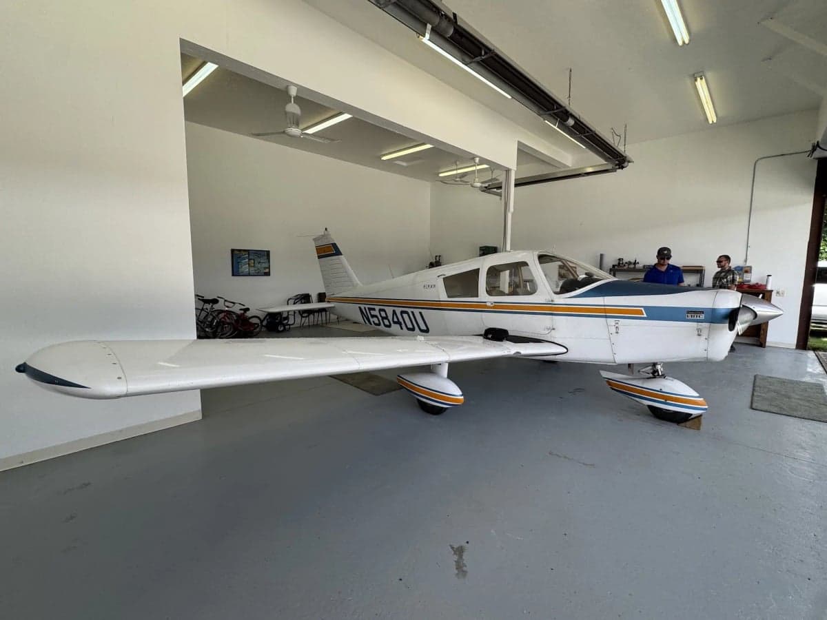 A Piper aircraft with tail number N5840U parked inside a hangar.