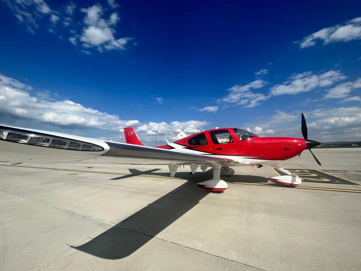 TC-SFA aircraft with red and white paint scheme on the tarmac.