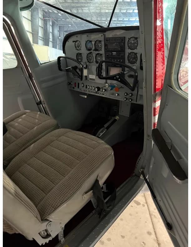 Interior view of the Cessna 172 cabin showing the front seats and part of the cockpit.