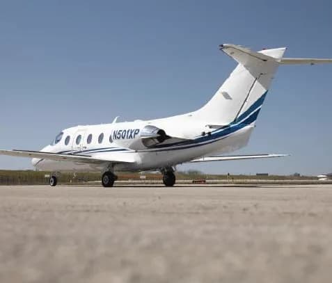 A Hawker 400XP aircraft with registration N501XP parked on the tarmac.