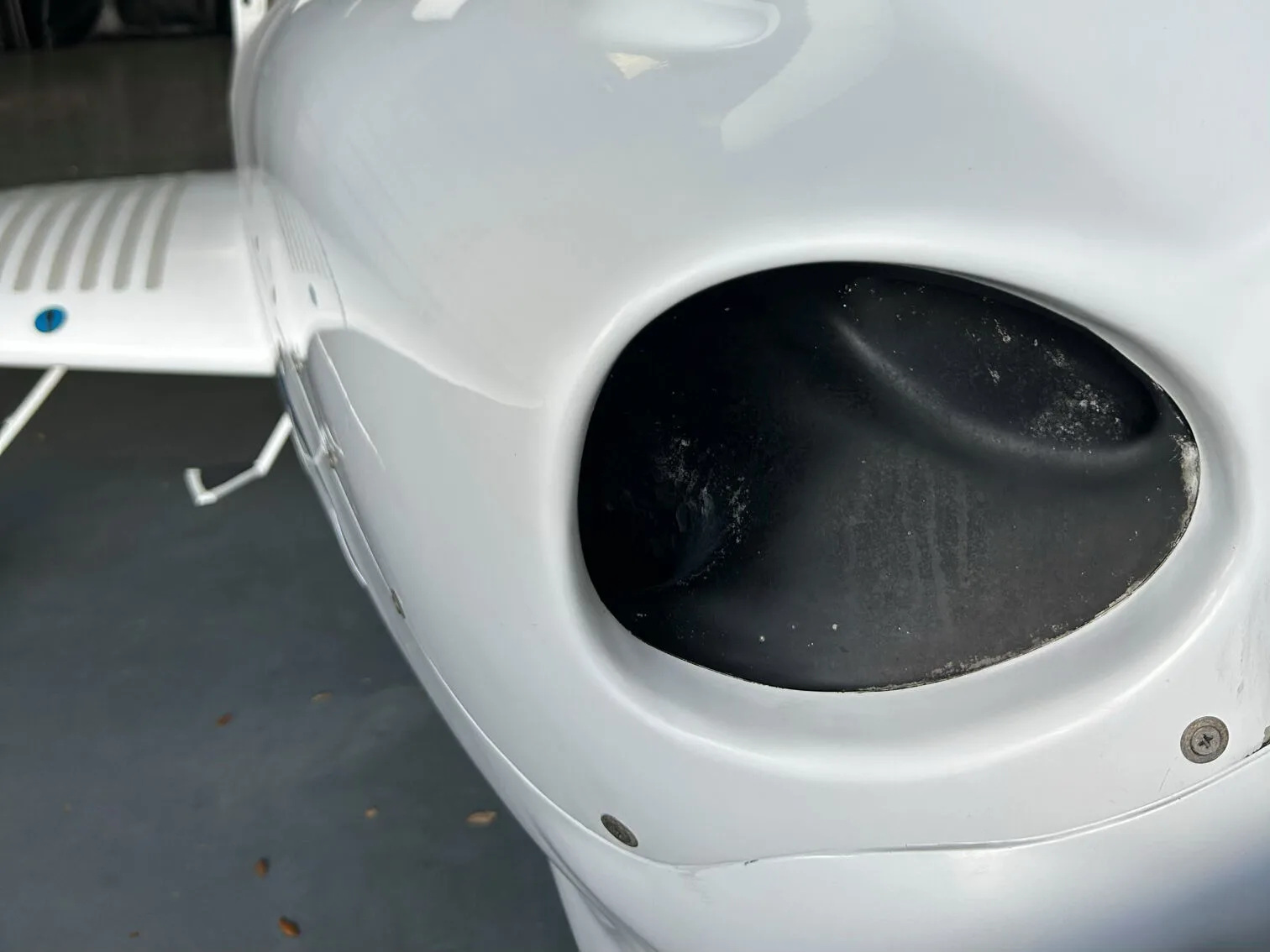 Close-up view of the engine air intake on the side of a white Diamond DA40 aircraft.