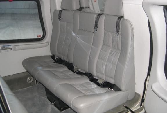 A view of the interior of the aircraft with gray leather seats.