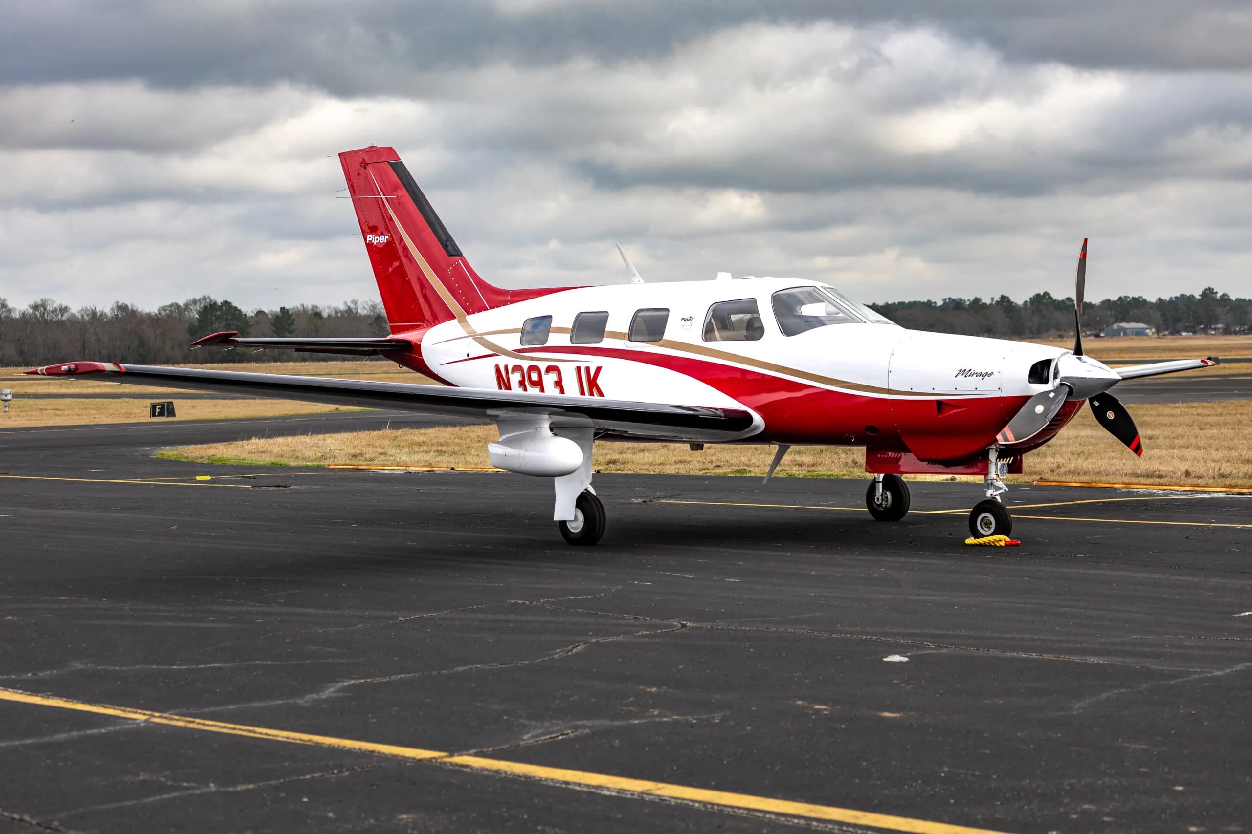 Piper Mirage N393JK parked on the tarmac, highlighting its sleek design.