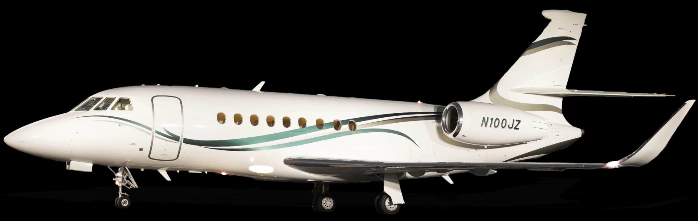 A white Dassault Falcon 2000LXS business jet with green and grey livery, registration N100JZ, on a black background.