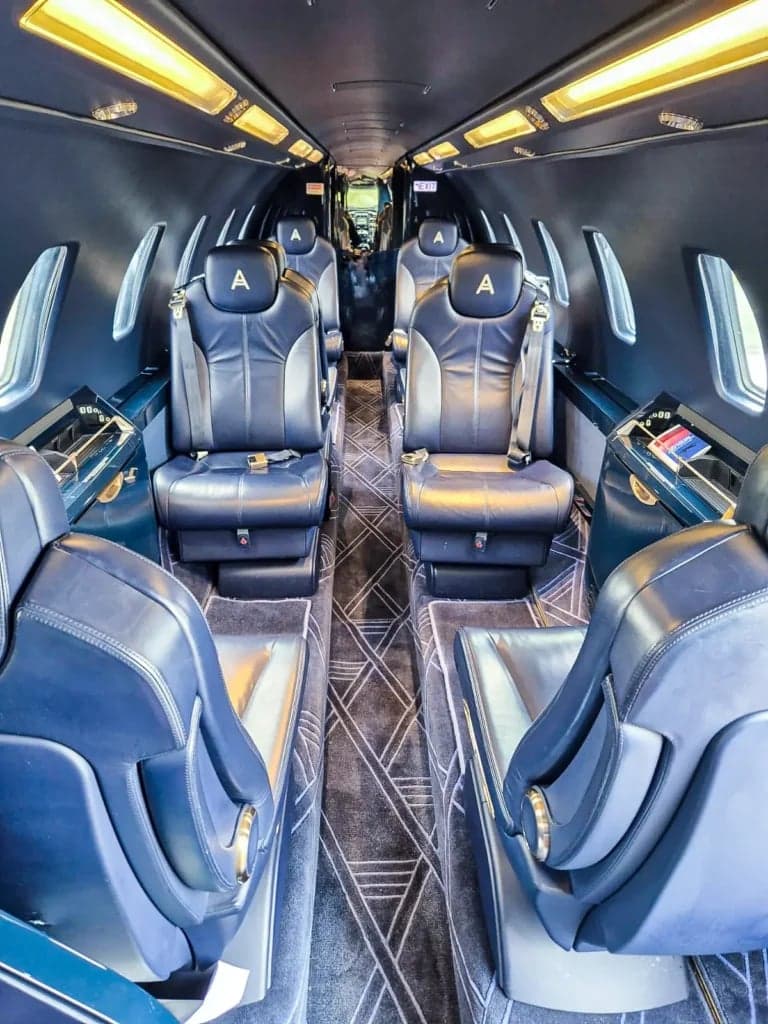 View of the aircraft's interior cabin with blue leather seats.