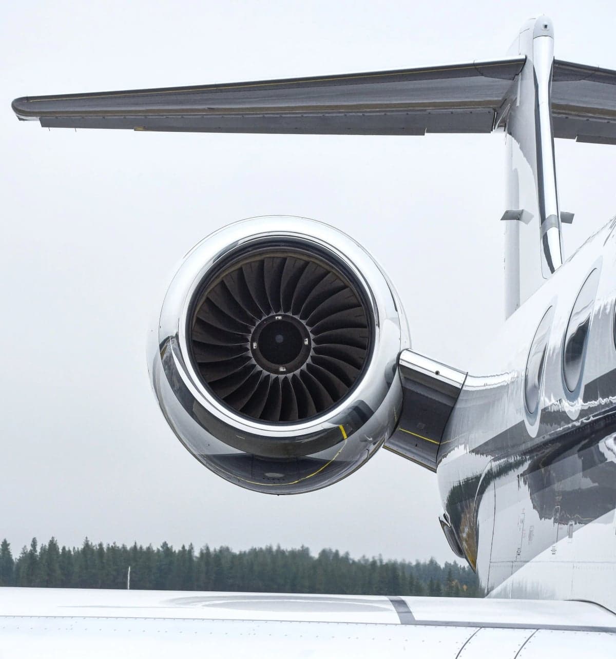 Close-up of a jet engine and tail section of a business jet.