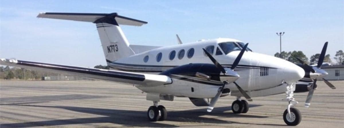 A King Air aircraft with registration N773 is parked on the tarmac.