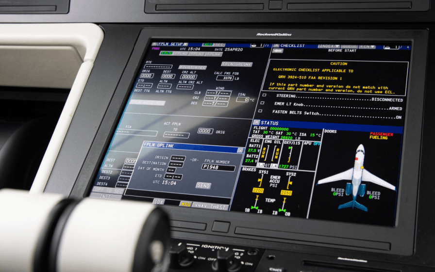 A close-up of a cockpit display screen showing flight plan details, system status, and an aircraft diagram.