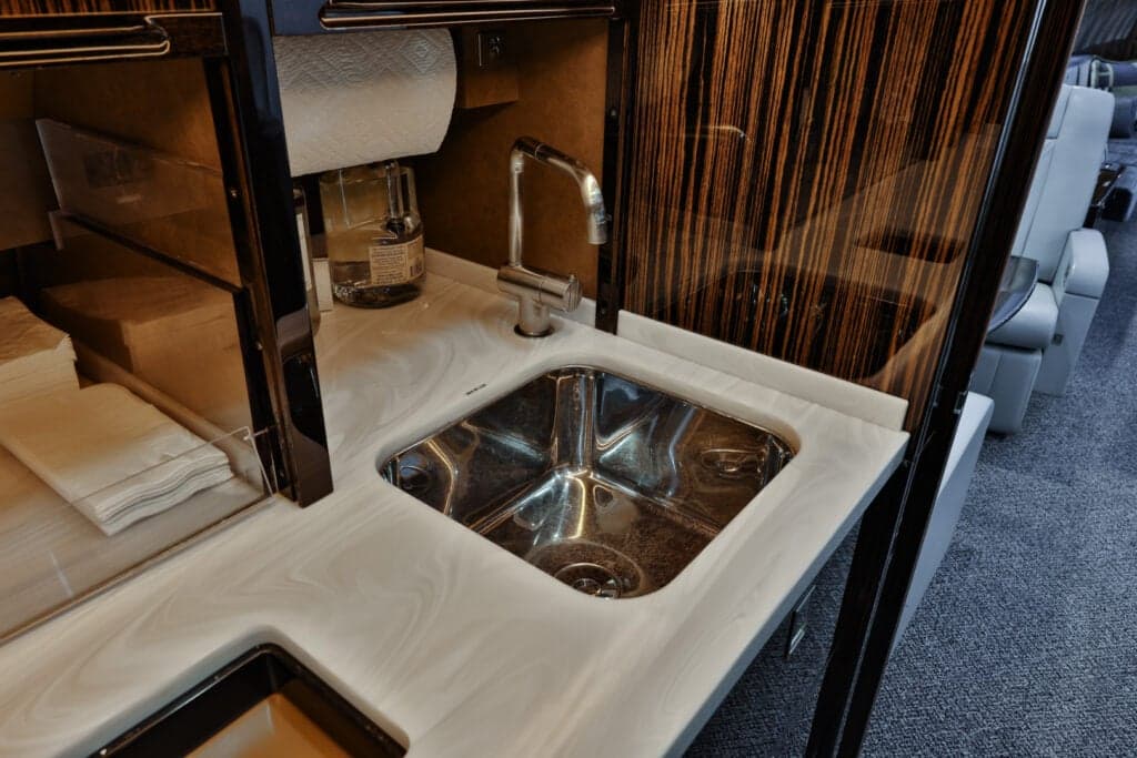 Close-up of the aircraft interior showing a sink and countertop in the galley area.