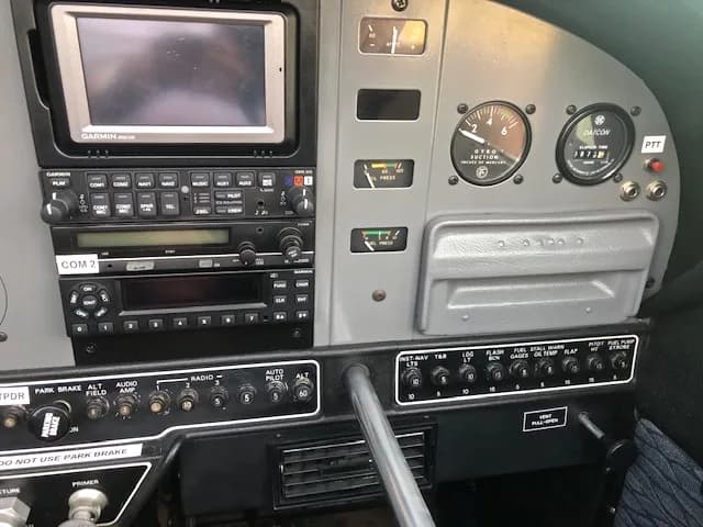 Close-up of the aircraft's instrument panel with various gauges and avionics.