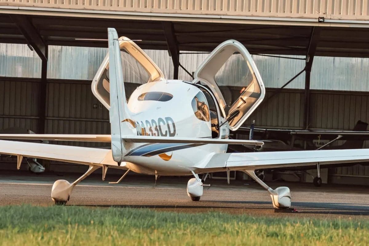 Rear view of Cirrus SR22 aircraft N133CD with doors open.