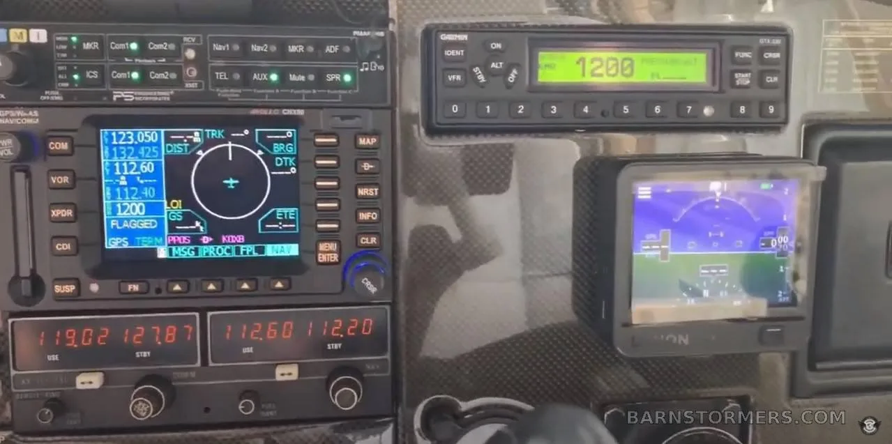 A close-up of the aircraft's avionics stack, showing a Garmin GPS/NAV/COM unit and other radio equipment.