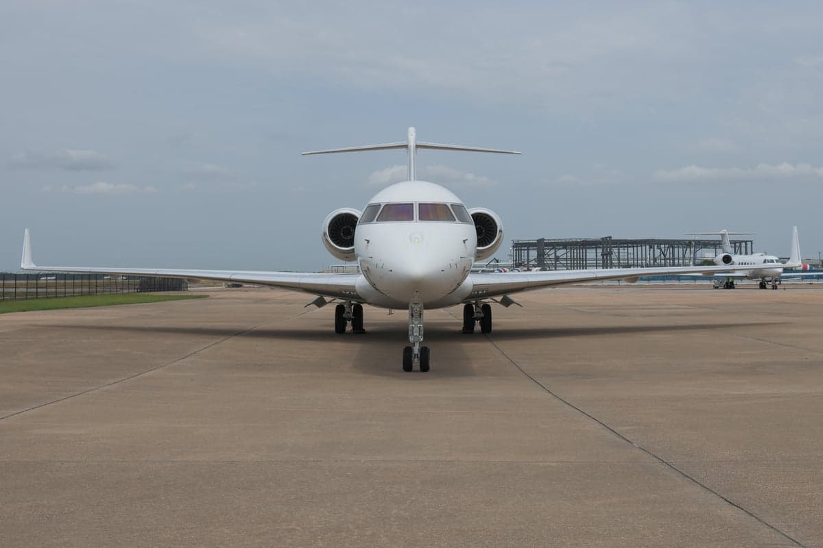 Front view of a white Bombardier Global Express aircraft on the tarmac.