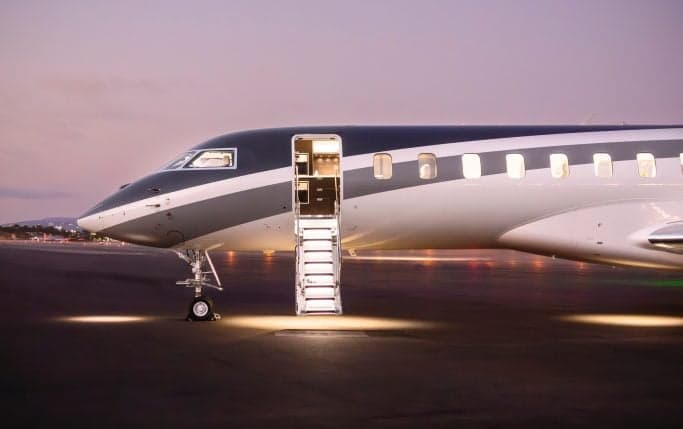 A Global 7500 aircraft with an open door and stairs extended on the tarmac.
