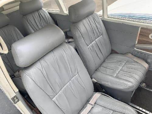 The interior of the aircraft features gray leather seats.