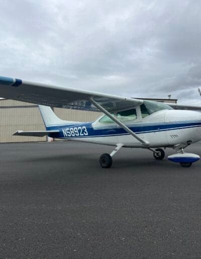 Side view of the Cessna 172 aircraft with blue and white paint scheme.