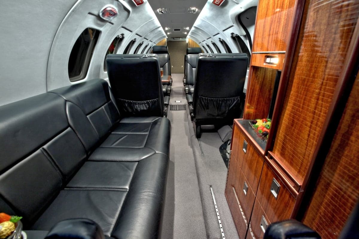 The interior of the Cessna Citation CJ1+ features a leather divan and wood cabinetry.