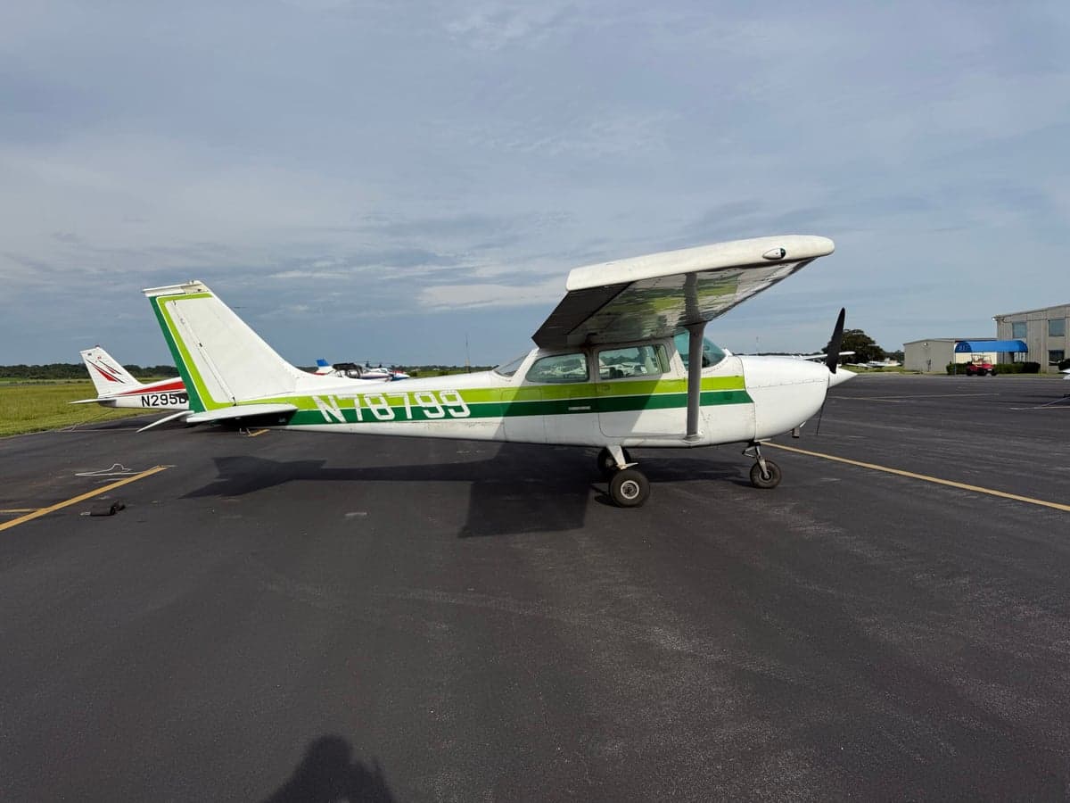 A Cessna 172 Skyhawk with green and white paint scheme parked on the tarmac.