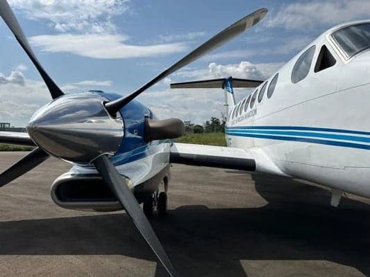 Close-up of the King Air aircraft's propeller and nose, with the rest of the aircraft in the background.